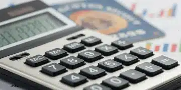 Calculator displaying financial data with Social Security card, representing 2026 COLA increase.