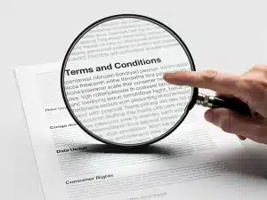 Magnifying glass examining data privacy terms and conditions, symbolizing consumer understanding of new regulations.